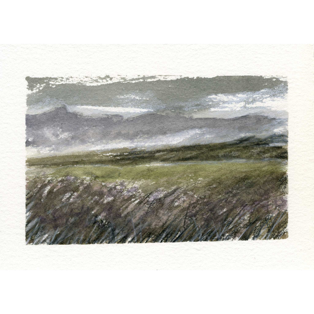 A watercolor landscape painting of a moody, misty field with purple wildflowers in the foreground and distant gray-green hills under a cloudy sky, presented on a textured white paper background.