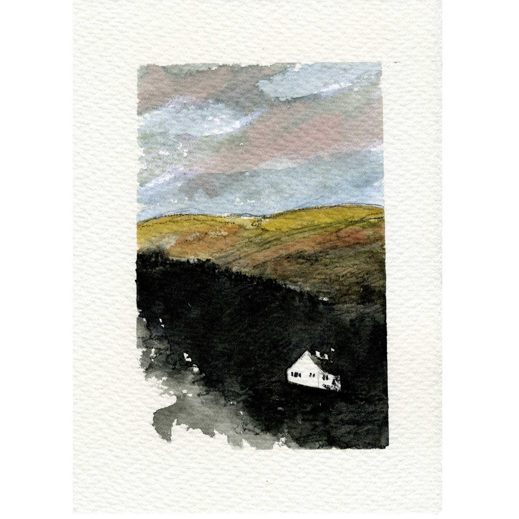 A watercolor landscape art print featuring rolling hills in muted yellow, brown, and dark green-black tones, with a small white house near the bottom and a cloudy sky above, centered on a textured white paper background.