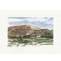 A watercolor landscape painting on textured white paper, depicting a brown hill under a blue and white sky with green fields in the foreground.