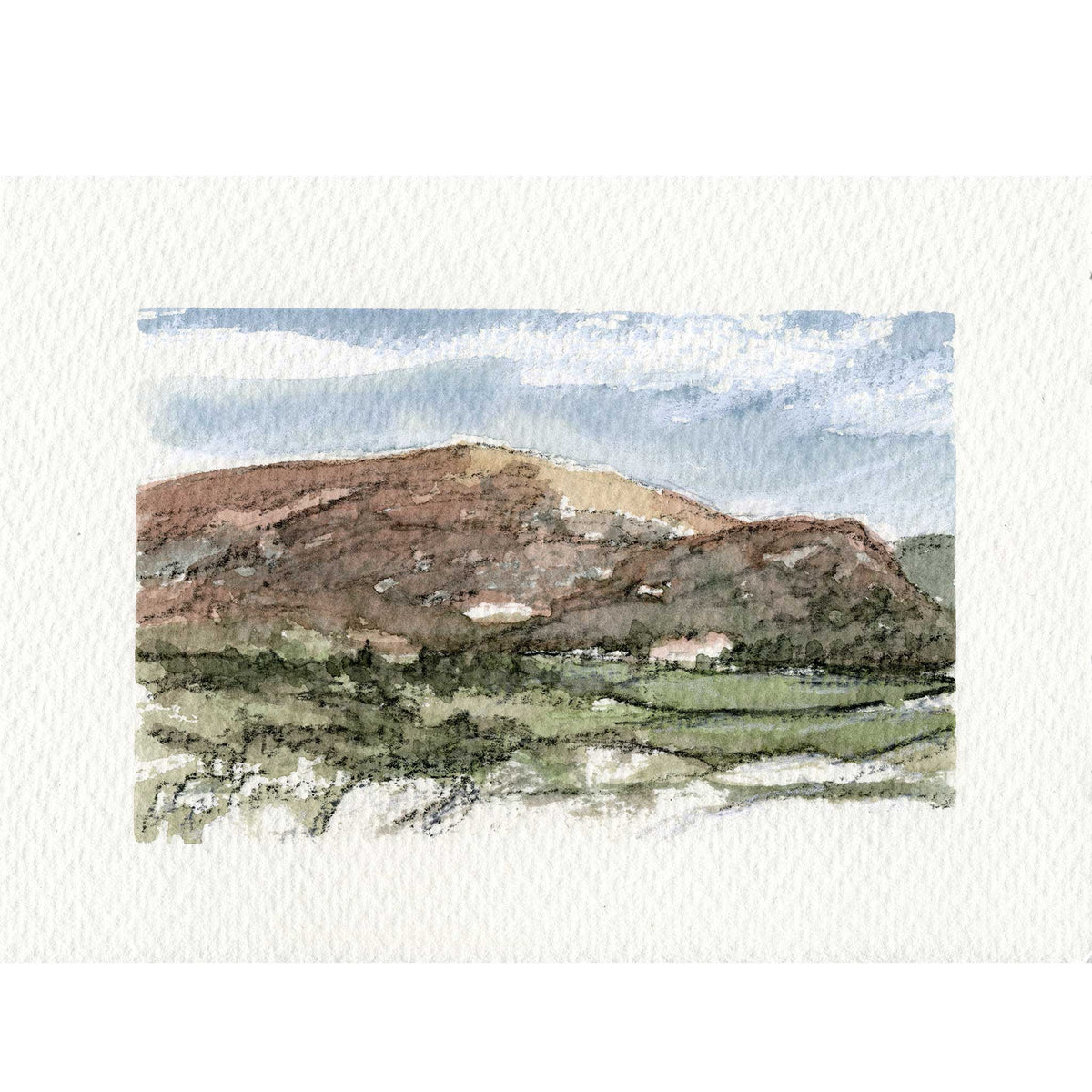 A watercolor landscape painting on textured white paper, depicting a brown hill under a blue and white sky with green fields in the foreground.